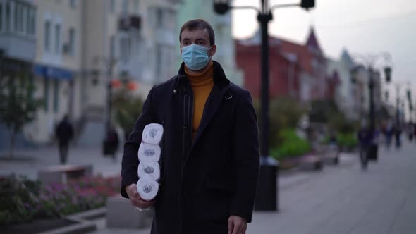 Men Walking in Medical Mask with Toilet Paper During the Second Wave Quarantine Coronavirus COVID-19