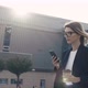 Stylish Girl in Suit walking down the street, texting Messages on Smartphone. - VideoHive Item for Sale