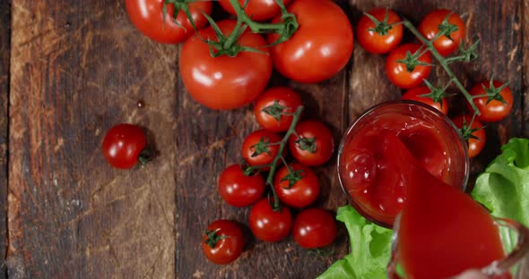 Tomato Juice Is Poured From a Jug Into a Glass. 