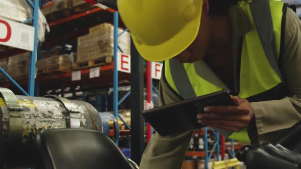 Young female worker driving forklift in a warehouse