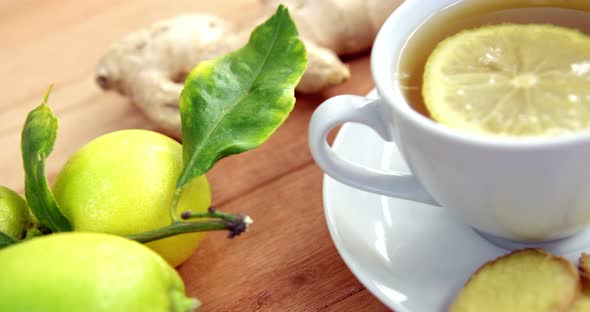 Lemon tea with lemon, sliced ginger and herb