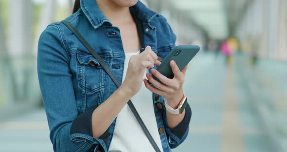 Woman work on mobile phone in city