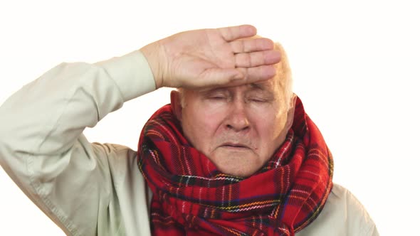 Sick Grandpa Wearing a Scarf Touching Forehead Having Fever