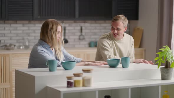 Funny Couple Rear View Dancing While Cooking Together in Kitchen Young Active Family Having Fun