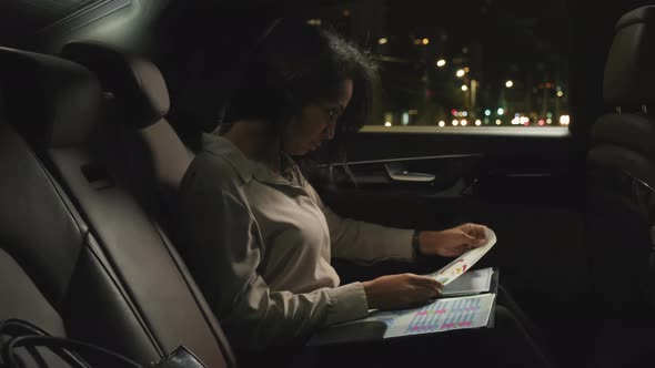 Business Lady Doing Paperwork At Backseat