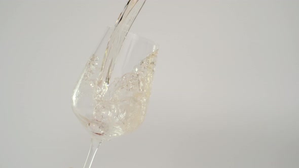 Slow Motion of White Wine Splashing in Tilted Glass at 1000 Fps