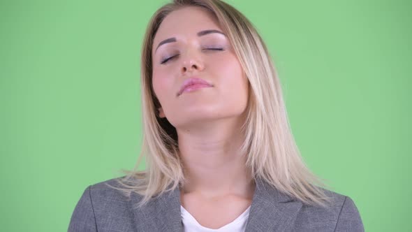 Face of Happy Young Blonde Businesswoman Relaxing with Eyes Closed