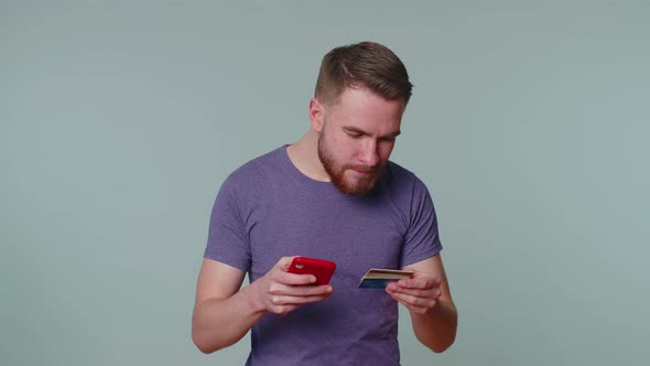 Tourist Man Using Credit Bank Card and Smartphone While Transferring Money Purchases Online Shopping