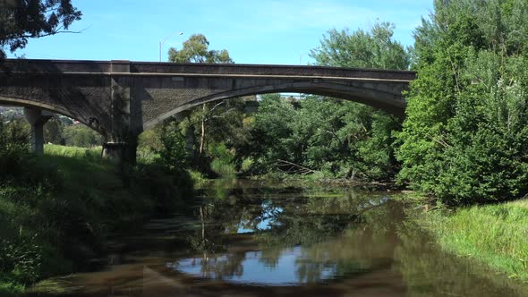 AERIAL Towards Historic Cement Arched Bridge Over Moorabool River Geelong