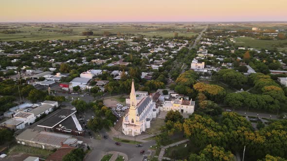 Aerial establishing shot of Virgen Niña church in Villa Elisa town, Argentina