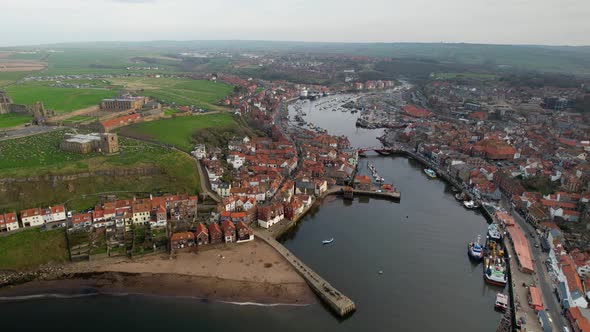 Aerial ultra wide view of Whitby harbor in Whitby, North Yorkshire, England with river and buildings