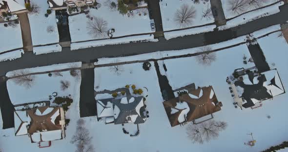 Aerial View of Snowed in Traditional Housing Suburbs in Snow on Trees in Winter Panorama Early