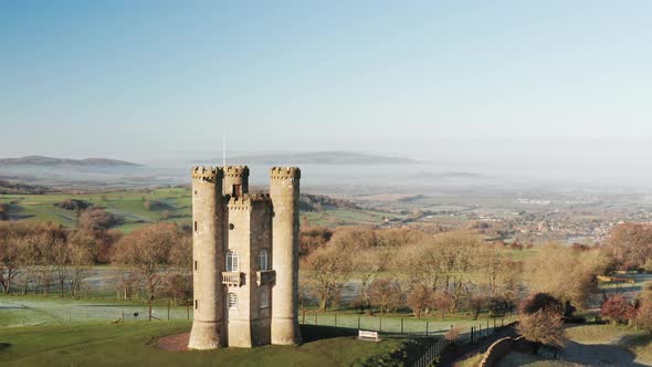 Aerial drone video of Broadway Tower, a famous old building landmark in The Cotswolds Hills, iconic 