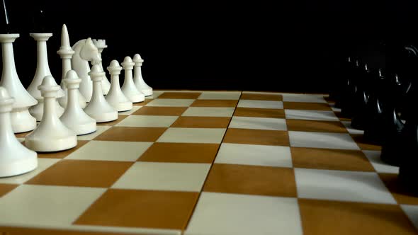 Chess on a chessboard. Shooting on a black background.