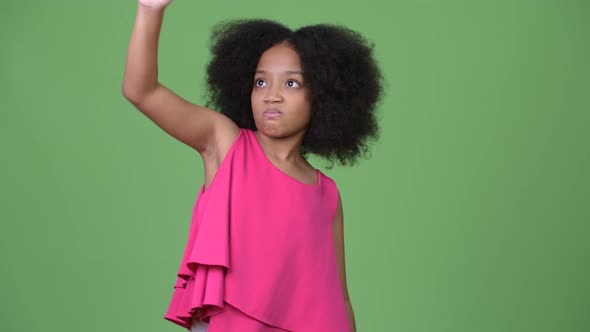 Young Cute African Girl with Afro Hair Holding Empty Coffee Cup Upside Down