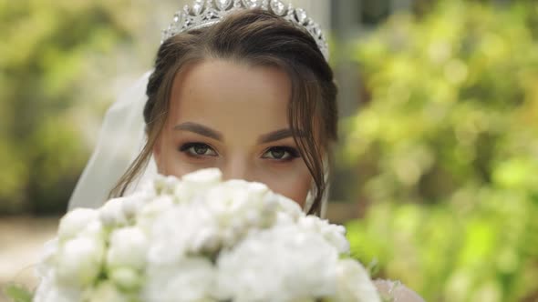 Wedding Bouquet in the Hands of Pretty Bride in the Park. Wedding Day. Engagement. Slow Motion