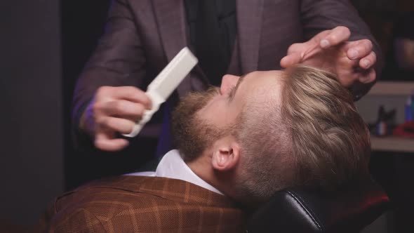 Man Hairdresser Doing Haircut Beard Adult Men in the Men's Hair Salon