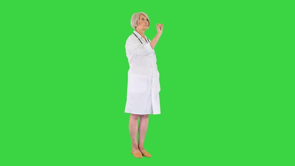 Healthcare Medicine and Technology Concept Senior Female Doctor Pointing To Something or Pressing