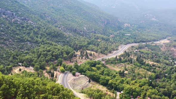 aerial drone passing across a highway road in the rural Taurus Mountain landscape of Antalya Turkey