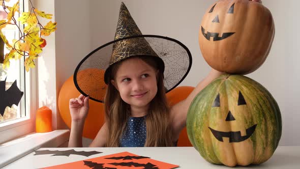 Smiling Happy Little Girl in Witch Costume Preparing for Halloween Party at Home