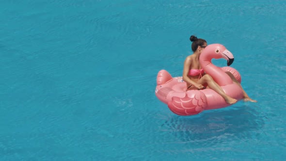 Woman Swimming on a Blue Water Pool