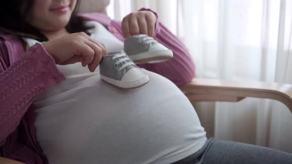 Happy Pregnant Woman and Expecting Baby at Home