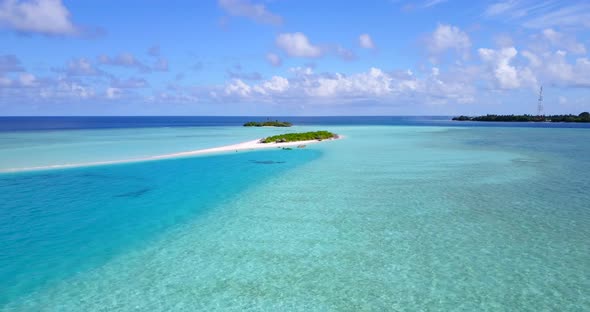 Beautiful aerial travel shot of a sandy white paradise beach and aqua blue water background in colou