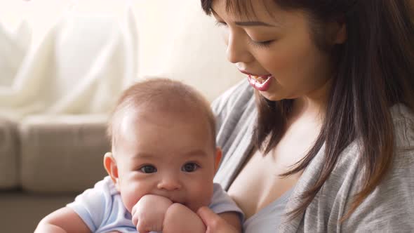 Happy Young Mother with Little Baby at Home