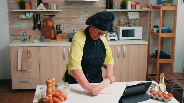 Senior Woman Looking Recipe at the Digital Laptop