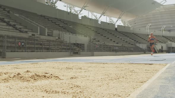 Caucasian athlete doing long jump