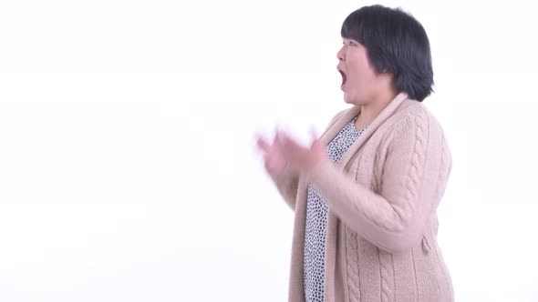 Surprised Overweight Asian Woman Touching Something and Ready for Winter