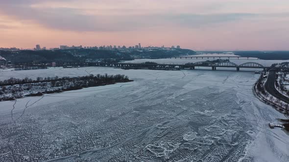 View From Drone at Frozen City River with Bridges and Residential Districts Tracking Shot