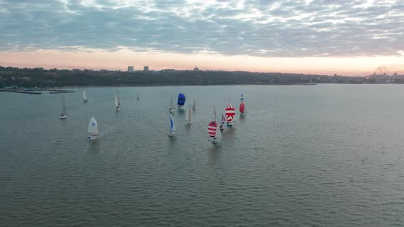 Top View of Floating Sailing Yachts on Background of City. Competition of Sailing Yachts