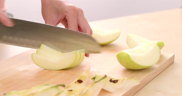 Cutting apple on the cutting board