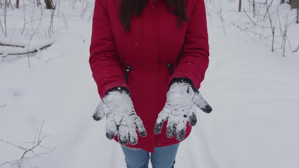 Woman's Hands in Gloves with Snow