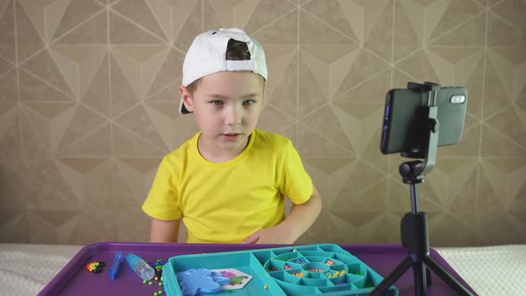 Boy Blogger Emotionally Tells Something To the Camera of a Smartphone