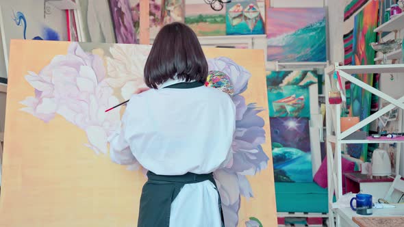 Woman Artist Working with the Big Painting at Workshop