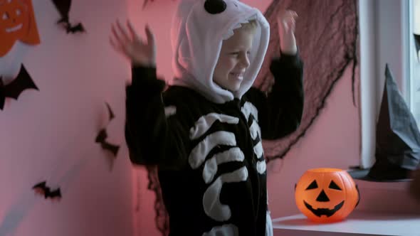 Halloween Kids Happy Dancing Boy in Halloween Skeleton Costume at Home