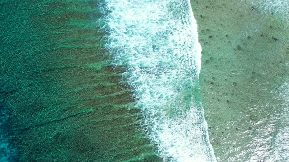 Natural birds eye clean view of a white paradise beach and blue water background in 4K