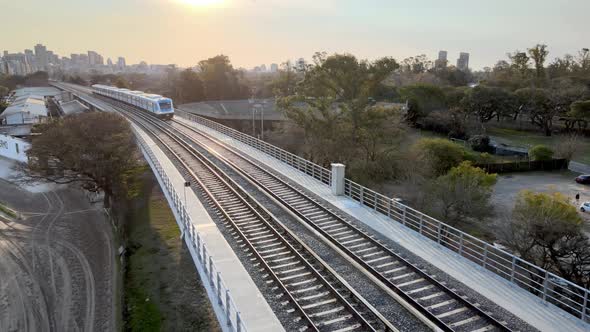 Close up shot of railroad infrastructure with argentina public transportation mitre train departing