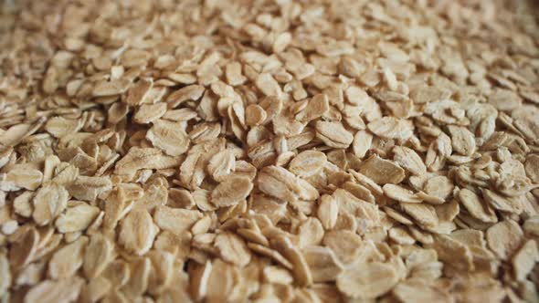 Uncooked Oatmeal Flakes Falling Down