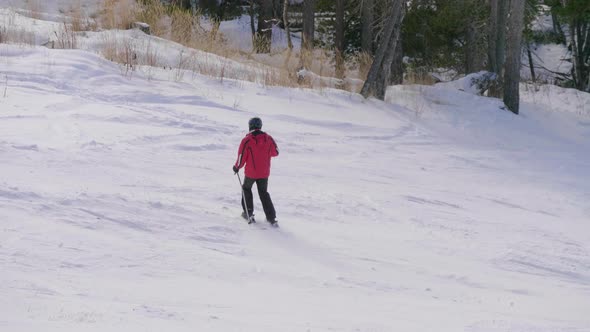 Skier Skiing and People on Snowboards Ride Down the Slope on Ski Resort in Mountains Winter.