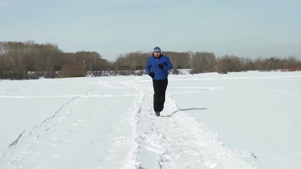 Young Man Is Running In Winter