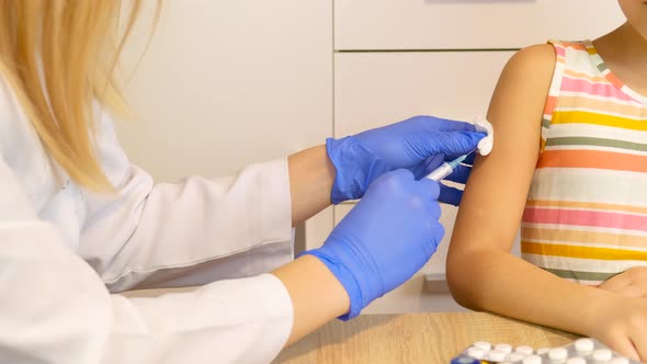 Doctor Gives the Vaccine to the Girl