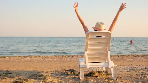 Pretty Woman Relaxing on the Evening Beach