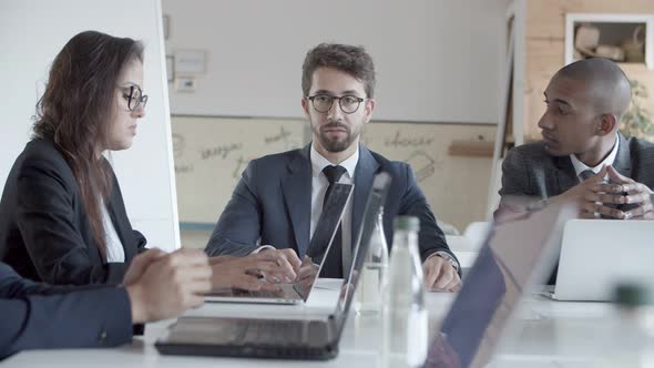 Thoughtful Managers Communicating During Meeting