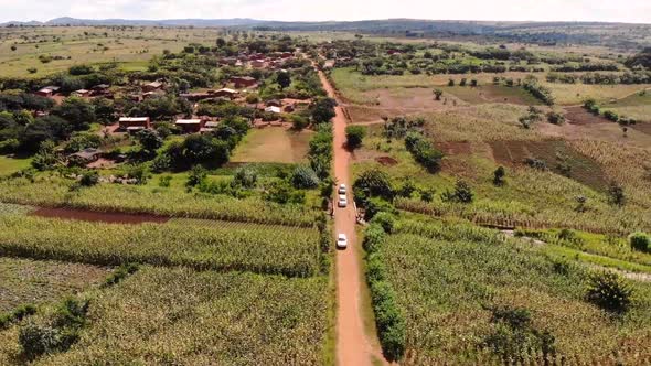 Three Cars Driving on a Dirt Road in Africa, Journey Across Malawi