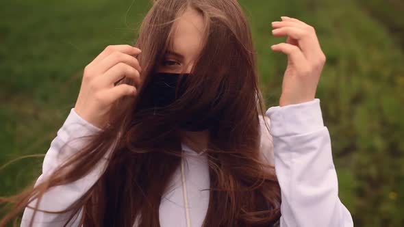 Woman in Black Mask Puts on a Hood Pandemic Covid19 Coronavirus