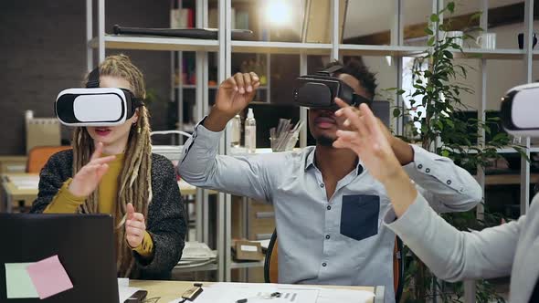 People in Virtual Reality Headset which Working on Imaginary Screen in Modern Office Room