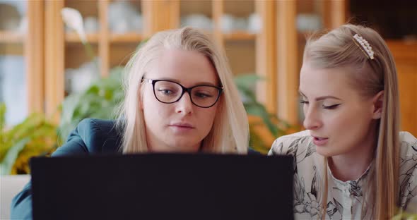 Female Colleagues Discussing Business Strategy In Office